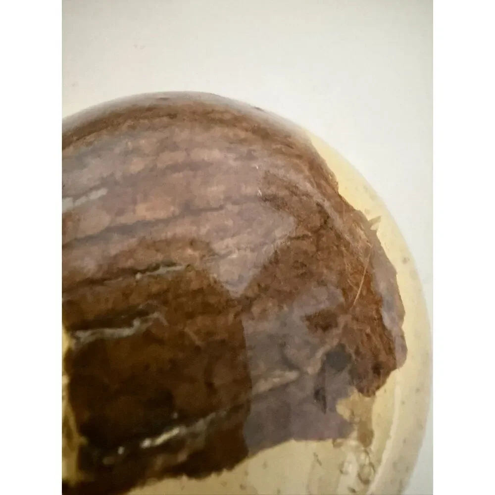 Vintage homemade paperweight with cloth or wood object